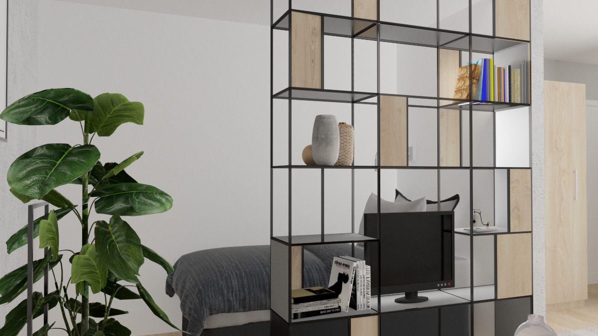 Salon z łóżkiem sypialnianym oddzielony ażurowym regałem z elementami drewna, na półkach dekoracje i książki, widoczny telewizor i roślina doniczkowa.