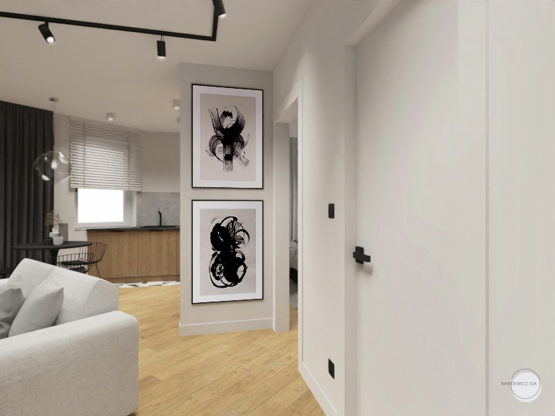Wizualizacja wnętrza mieszkania: salon z kuchnią, drewniana podłoga, biała sofa, dwie abstrakcyjne grafiki w czarnych ramach na ścianie, czarna lampa sufitowa szynowa.