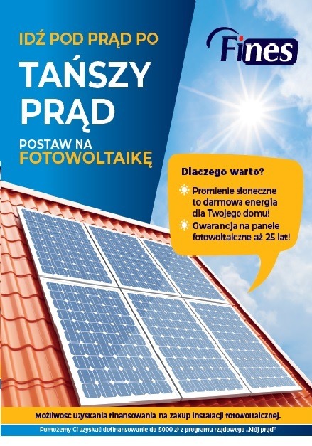 Reklama paneli słonecznych na dachu z tekstem 'Idź pod prąd po tańszy prąd. Postaw na fotowoltaikę' i informacją o 25-letniej gwarancji.