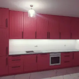 Kompletna zabudowa kuchenna w odcieniach czerwieni z frezowanymi frontami, szarym blatem i oświetleniem podszafkowym, widoczna lampa sufitowa z kloszem.