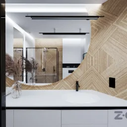 Nowoczesna łazienka z umywalką nablatową, drewnianą ścianą w geometryczne wzory, czarną armaturą i dekoracyjnymi trawami w szklanych wazonach, widok na kabinę prysznicową w lustrze.