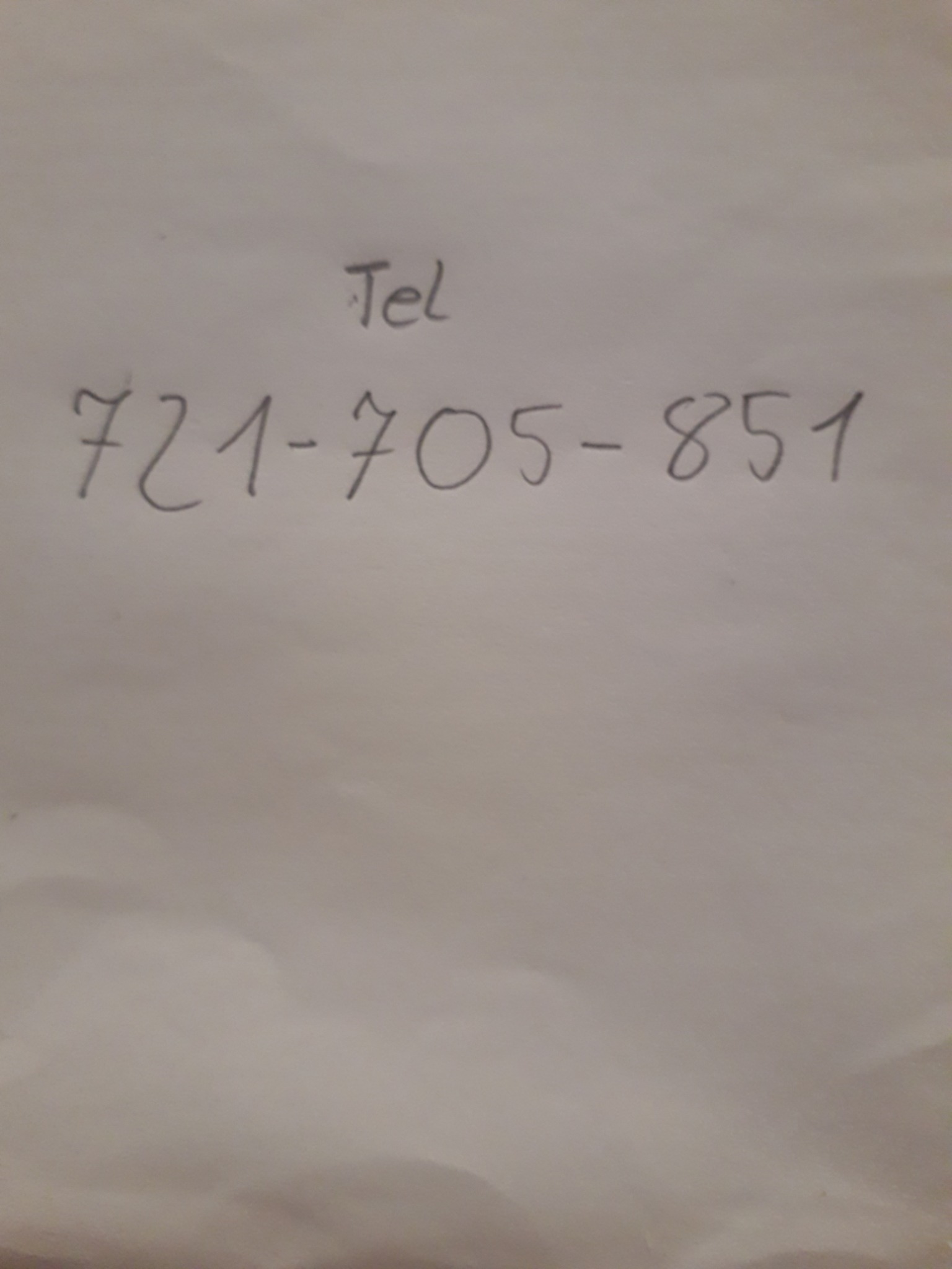 Numer telefonu 721-705-851 napisany ręcznie na kartce papieru, z dopiskiem 'Tel' powyżej.