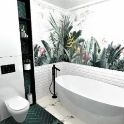 Wizualizacja łazienki z białą wanną wolnostojącą, toaletą i zabudową meblową z zielonymi akcentami, tapeta z motywem tropikalnych roślin, białe płytki typu metro.