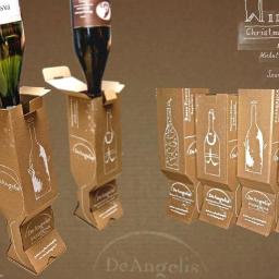 Zrealizowany projekt opakowań na wino, w których butelka stoi do góry dnem. Tekturowe pudełko opatrzone jest grafiką odręczną.