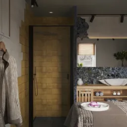 Nowoczesna łazienka z kabiną prysznicową wyłożoną kwadratowymi, złotymi płytkami, umywalką wpuszczoną w drewniany blat z szafką, oraz dekoracyjnym stołem z kwiatem lotosu.