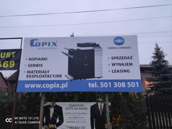Billboard reklamowy firmy Copix z ofertą sprzedaży, wynajmu, leasingu, serwisu i materiałów eksploatacyjnych do kserokopiarek Konica Minolta, widoczny numer telefonu i adres strony internetowej.