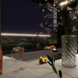 Nowoczesna kuchnia z marmurowym blatem, butelką różowego wina i kwiatami w szklanym wazonie. W tle widoczna zabudowa kuchenna z oświetleniem LED i dekoracyjna ściana.