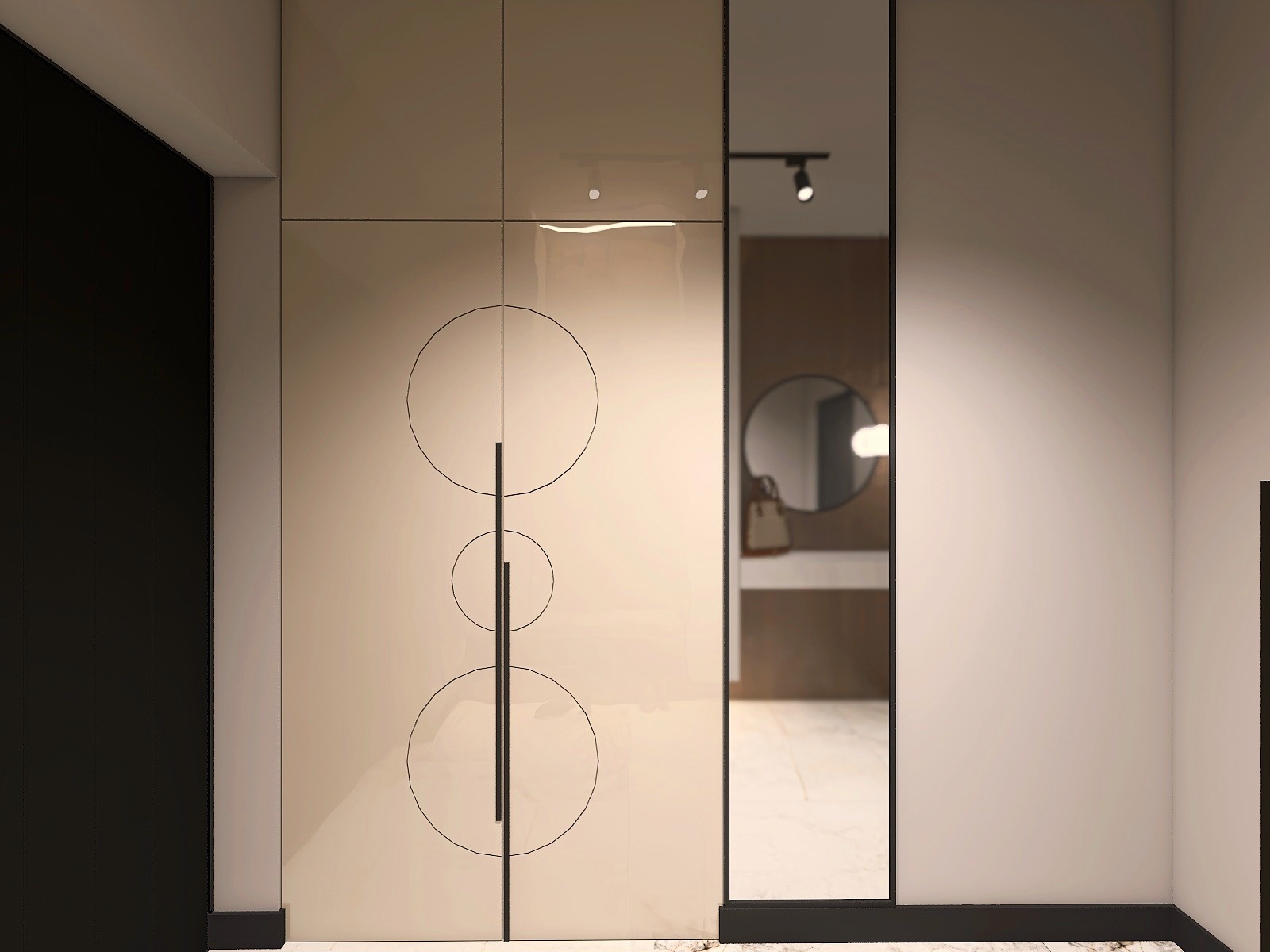 Beżowa szafa w przedpokoju z dekoracyjnymi okręgami i długimi uchwytami. W tle lustro z widokiem na łazienkę z okrągłym lustrem i torebką na blacie.