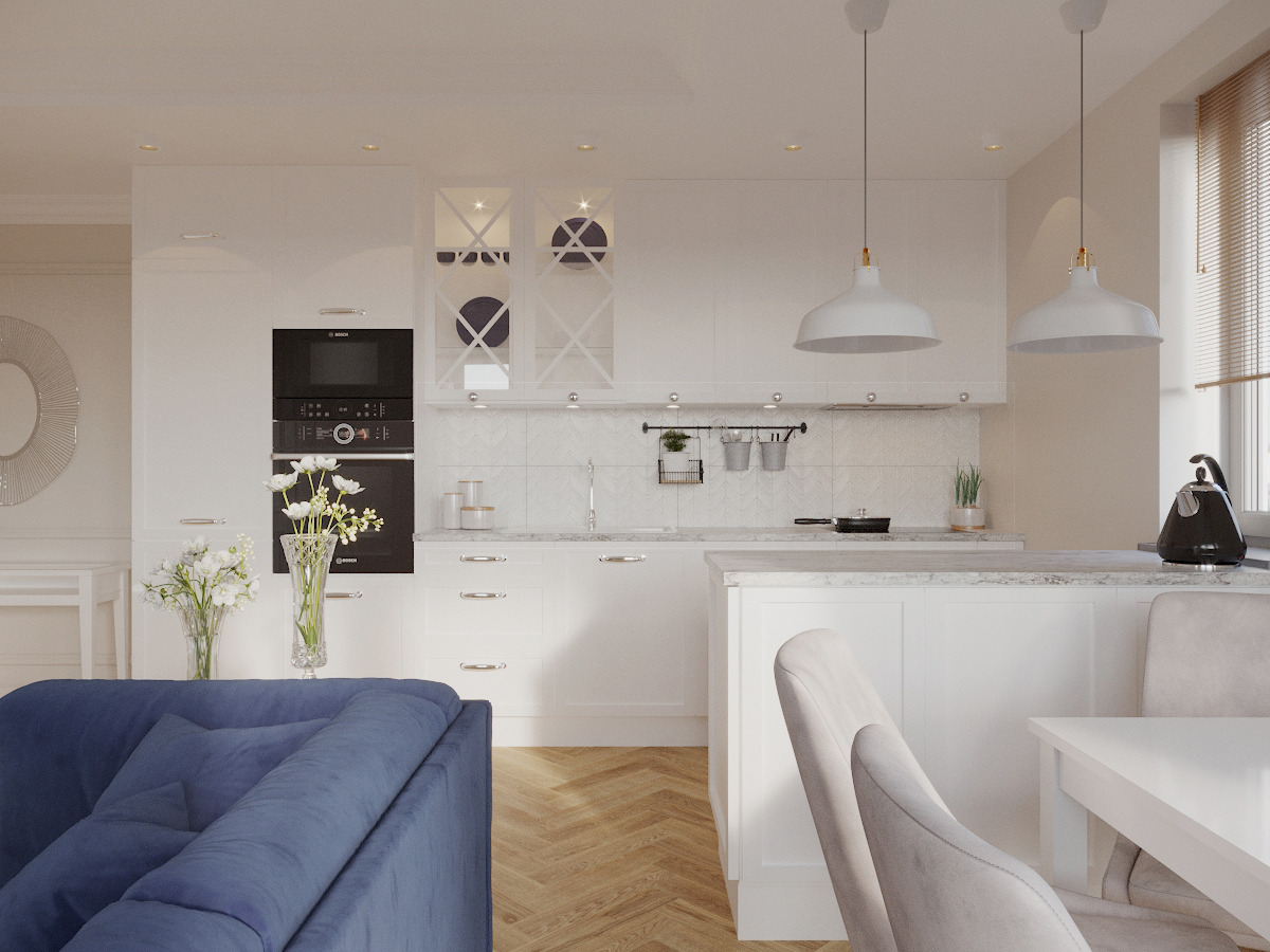 Jasna kuchnia w stylu klasycznym z wyspą, białymi szafkami, drewnianą podłogą w jodełkę i wiszącymi lampami w kształcie dzwonów, widok z salonu z niebieską sofą.