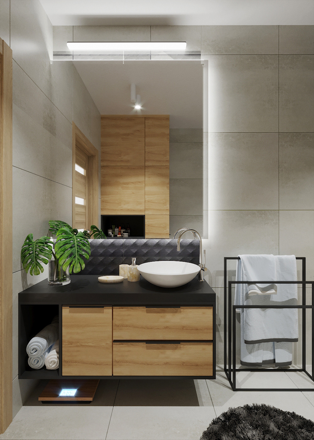 Nowoczesna łazienka z umywalką nablatową, czarnym blatem, drewnianymi szafkami, szarymi płytkami na ścianach i zieloną rośliną w szklanym wazonie