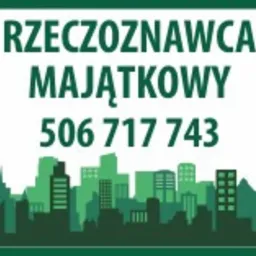Zielona tabliczka informacyjna z napisem 'RZECZOZNAWCA MAJĄTKOWY' i numerem telefonu 506 717 743, poniżej sylwetka miasta.