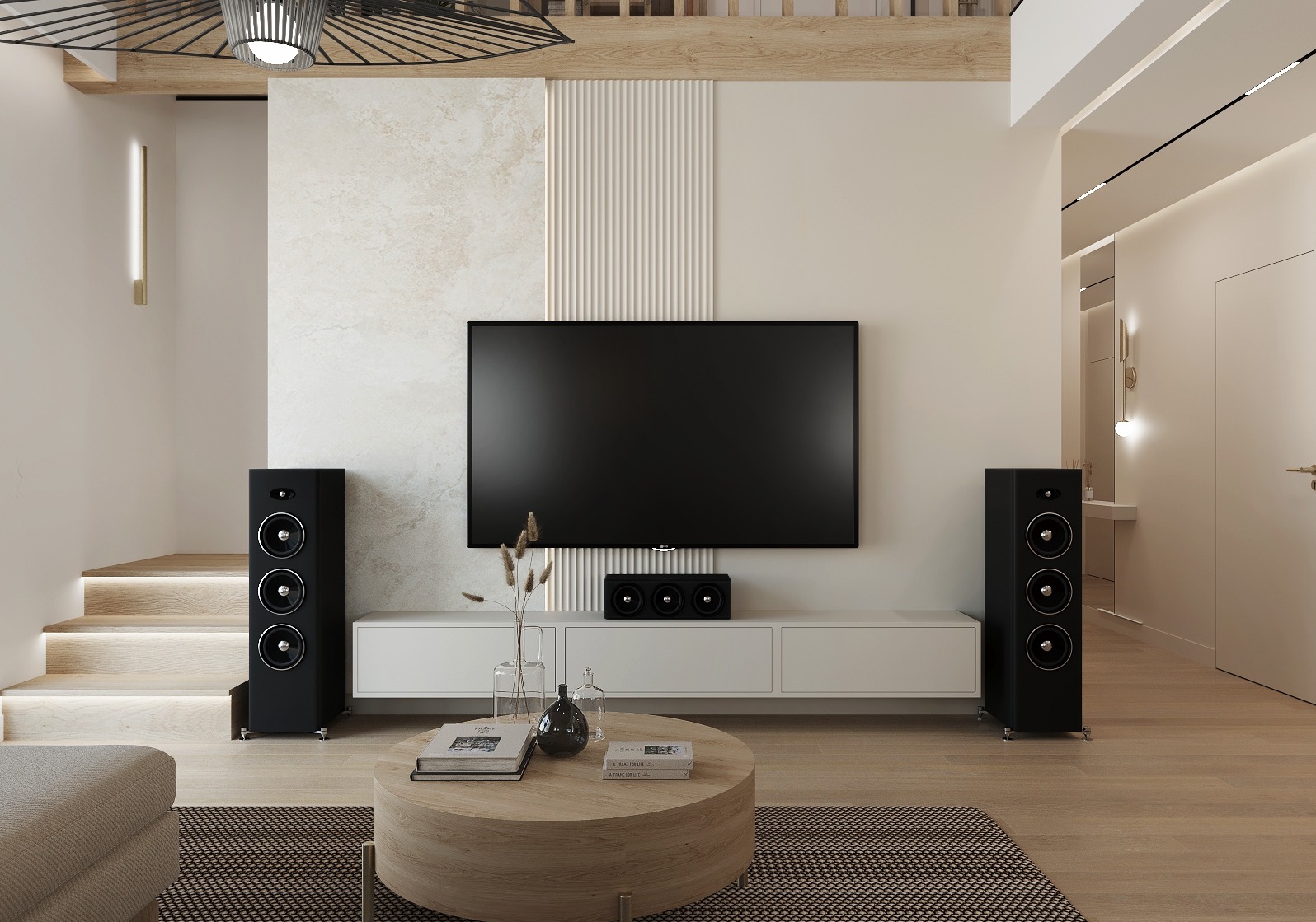 Elegancki salon z dużym telewizorem, głośnikami i okrągłym stolikiem kawowym. Neutralna kolorystyka, oświetlenie LED i drewniane akcenty tworzą nowoczesną przestrzeń.