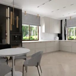 Jasna kuchnia z parkietem w jodełkę, czarnym wysokim zabudowaniem z oświetleniem i okrągłym stołem z szarymi krzesłami, widok na zieleń za oknem.