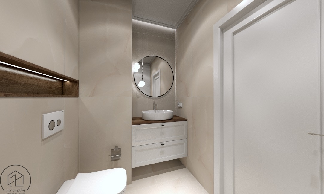 Nowoczesna łazienka w Bydgoszczy z beżowymi płytkami, okrągłym lustrem z podświetleniem, białą umywalką nablatową na drewnianym blacie i podwieszaną szafką, oraz wnęką z drewnianym wykończeniem...