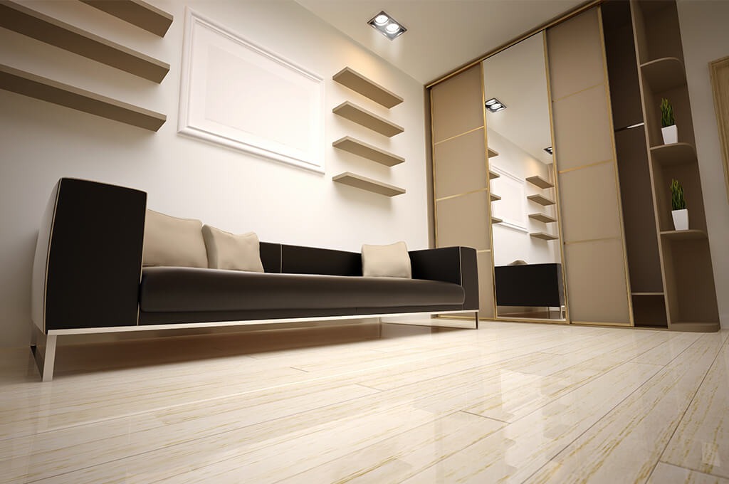 Nowoczesny salon z czarną sofą na metalowych nogach, beżowymi poduszkami, szafą przesuwną z lustrami i otwartymi półkami z roślinami, oraz rzędem wiszących półek na białej ścianie, widziany...