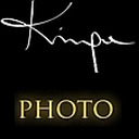 Czarno-złote logo z napisem 'PHOTO' i ozdobnym białym podpisem powyżej.