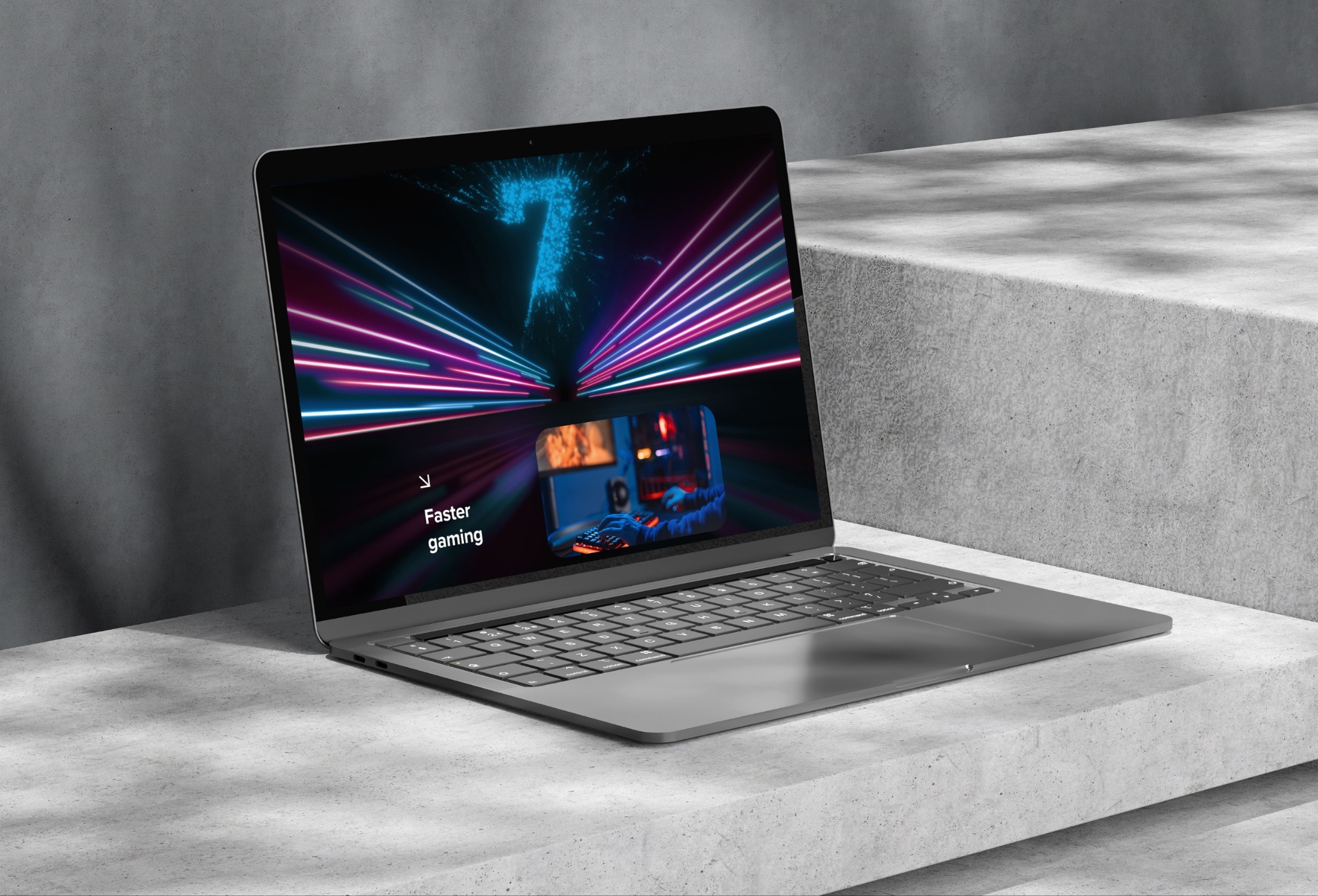 Laptop na betonowym podłożu wyświetlający dynamiczną grafikę z napisem 'Faster gaming' i miniaturą osoby grającej w grę.