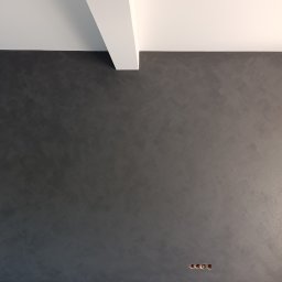 Usługi Remontowe Paweł Furgała - Ciemnoszara ściana z dekoracyjnym tynkiem o widocznej fakturze, łącząca się z białym sufitem i skośną belką. W dolnym rogu widoczne otwory pod gniazdka elektryczne.