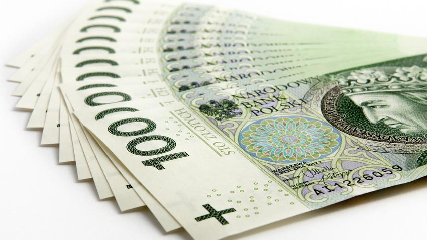 Stos banknotów 100 złotych ułożonych wachlarzowo na białym tle, z widocznymi detalami graficznymi i numerami seryjnymi.