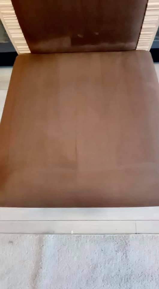 Brązowe, tapicerowane krzesło z jasnymi drewnianymi elementami, widoczne plamy na siedzisku, co sugeruje etap czyszczenia.