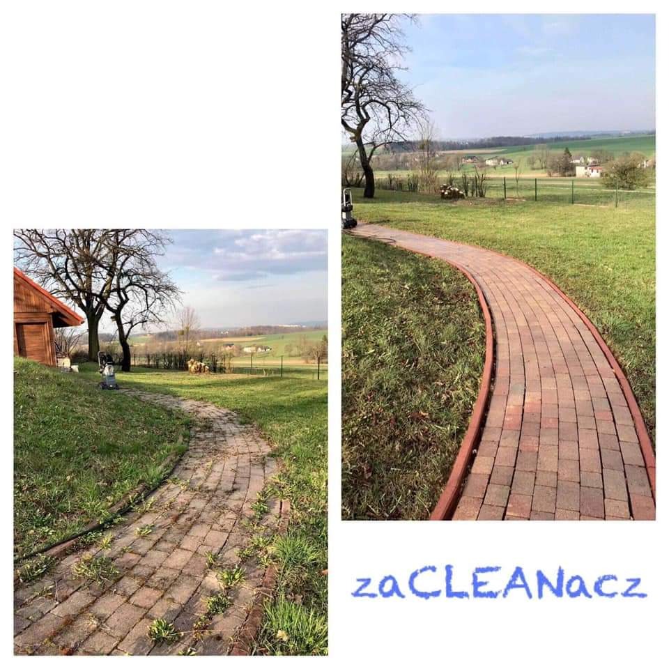 Porównanie stanu kostki brukowej przed i po czyszczeniu myjką ciśnieniową, widoczne dwie ścieżki z kostki, jedna porośnięta mchem i chwastami, druga czysta, na tle zielonego trawnika i krajobrazu...