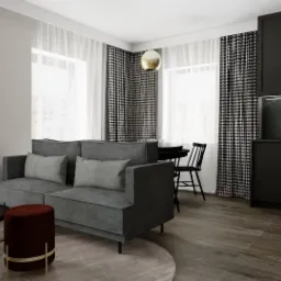Wizualizacja wnętrza mieszkania: szara sofa z poduszkami, okrągły stolik kawowy, bordowy puf, czarna zabudowa kuchenna z marmurowym blatem, stół z krzesłami oraz okna z białymi i wzorzystymi...