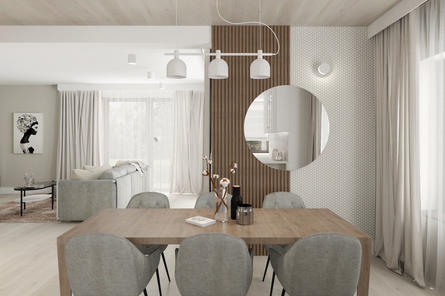 Jasne wnętrze jadalni z drewnianym stołem i szarymi krzesłami, oświetlone lampą wiszącą z trzema białymi kloszami, dekorowane wazonem z bawełną i okrągłym lustrem na ścianie z wzorzystą tapetą.