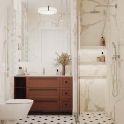 Foremen Sp. z o.o. - Elegancka łazienka z marmurowymi ścianami, brązową szafką pod umywalką, wiszącą toaletą i kabiną prysznicową typu walk-in z podświetlanymi półkami.
