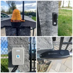 Szczegóły montażu automatyki bramy: lampa ostrzegawcza z anteną na słupku, fotokomórka, skrzynka sterownicza z logo firmy Elektrobim oraz napęd bramy.