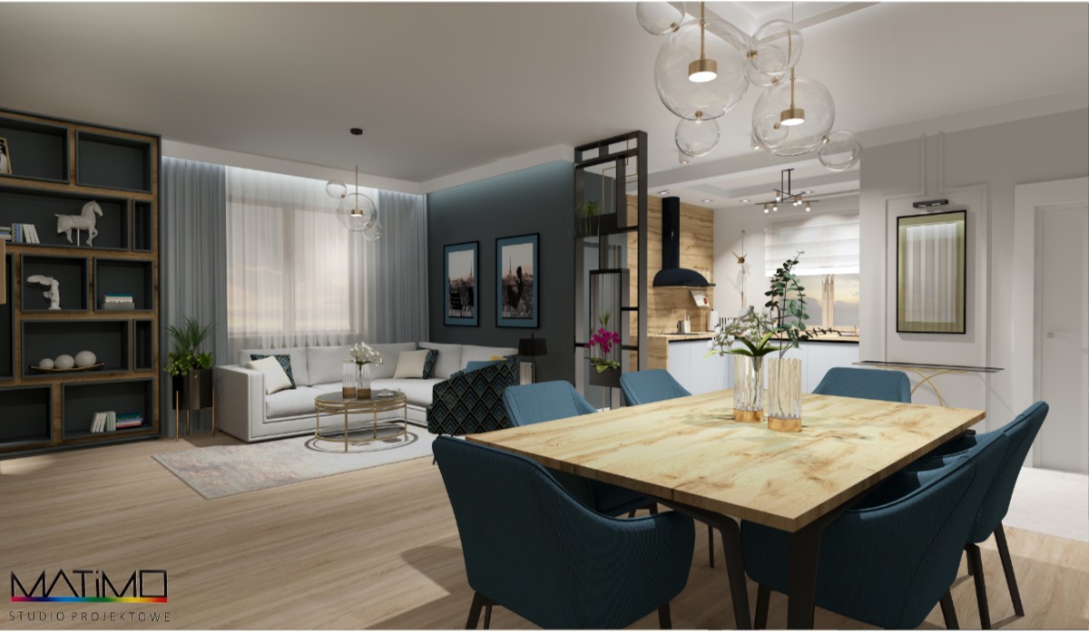 Wnętrze otwartej przestrzeni mieszkalnej z salonem, jadalnią i kuchnią w neutralnej kolorystyce z akcentami błękitu, z drewnianym stołem jadalnianym i dekoracyjną półką regałową.