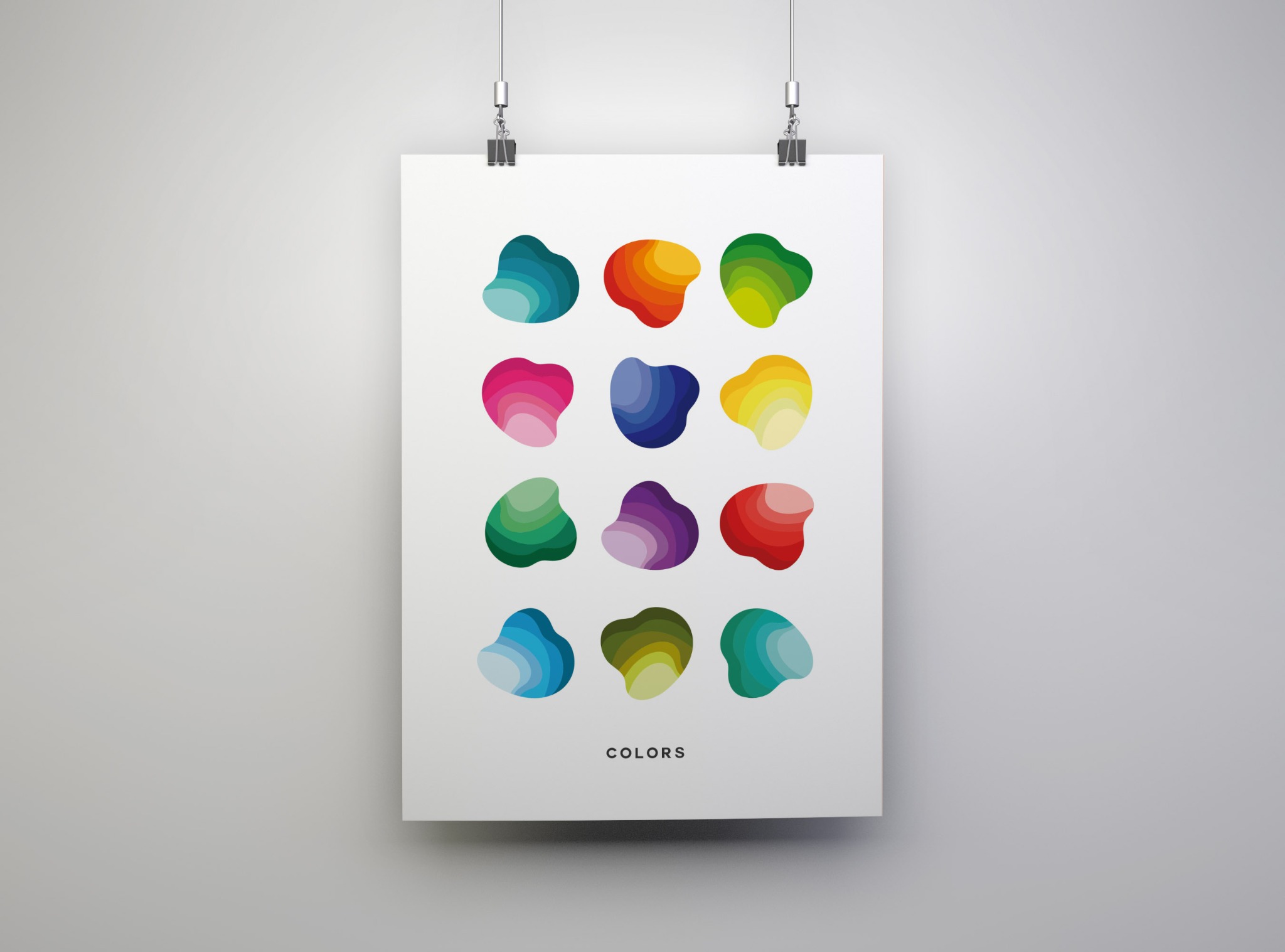 Plakat z abstrakcyjnymi, kolorowymi kształtami zawieszony na ścianie za pomocą klipsów.