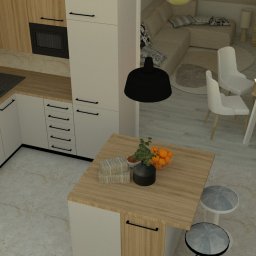 ULAN Krzysztof Ulański - Wnętrze mieszkania z aneksem kuchennym, wyspą i stołem jadalnym. Ujęcie z góry ukazuje nowoczesny design z drewnianymi i białymi elementami oraz dekoracjami.