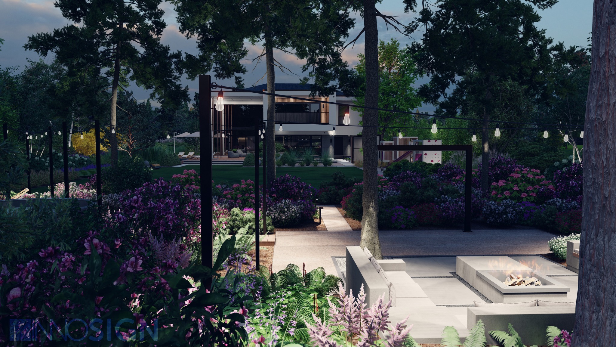 Nowoczesny ogród z paleniskiem i oświetleniem girlandami, widok na dom z kwitnącymi rabatami i ścieżką.