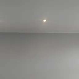 Szara ściana i sufit z dwoma punktowymi lampami LED, widok z dołu.