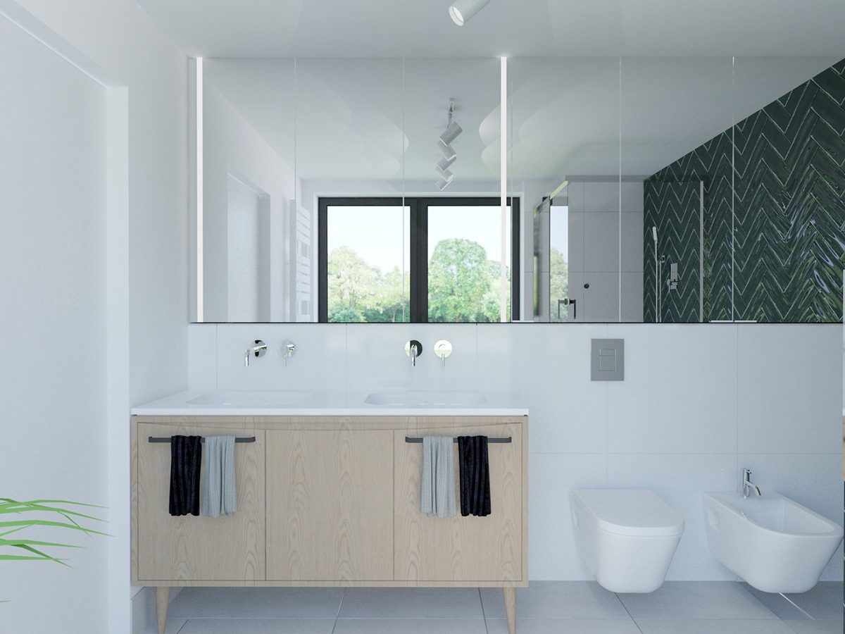 Nowoczesna łazienka z podwójną umywalką na drewnianej szafce, dużym lustrem z podświetleniem LED, toaletą i bidetem w bieli oraz zieloną ścianą w jodełkę widoczną w odbiciu lustra.