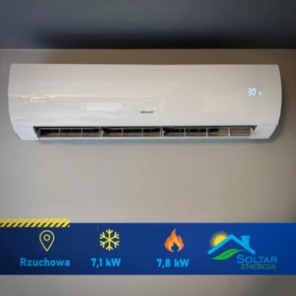 Biały klimatyzator ścienny z wyświetlaczem temperatury 30 stopni, zamontowany na szarej ścianie. Na dole grafika z logo firmy Soltar Energia i parametrami urządzenia.