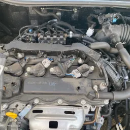 Silnik samochodu z widoczną instalacją gazową, wtryskiwacze gazu zamontowane na listwie, widoczne przewody i elementy silnika.