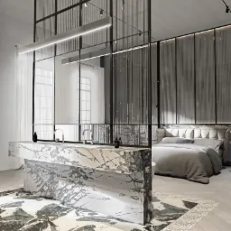 Nowoczesna łazienka z marmurową wyspą umywalkową, szklaną ścianką działową i sypialnią w tle, oświetlenie punktowe i linearne.