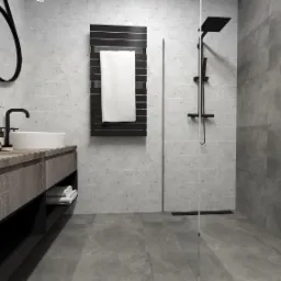 Nowoczesna łazienka w odcieniach szarości z kabiną prysznicową typu walk-in, umywalką nablatową i czarną armaturą.