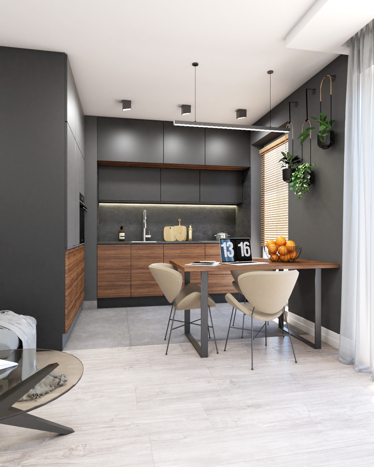 Nowoczesna kuchnia z ciemnymi szafkami i drewnianymi akcentami, stół jadalny z laptopem i misą owoców, minimalistyczne oświetlenie, wiszące rośliny w czarnych doniczkach.