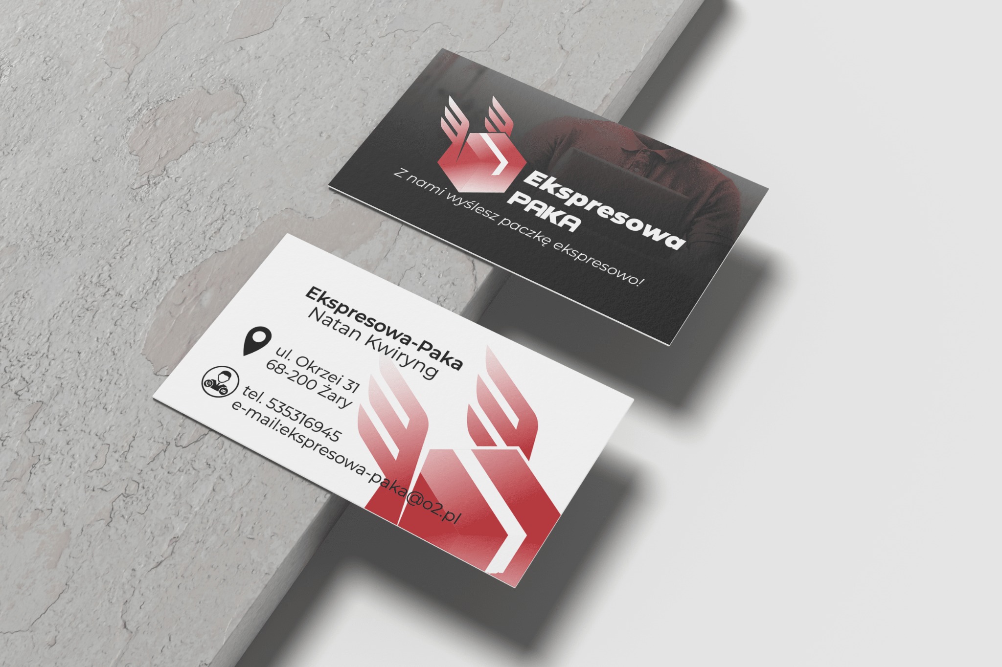 Dwie wizytówki firmy kurierskiej Ekspresowa-Paka z logo w kolorze czerwonym, leżące na jasnoszarym tle imitującym beton.