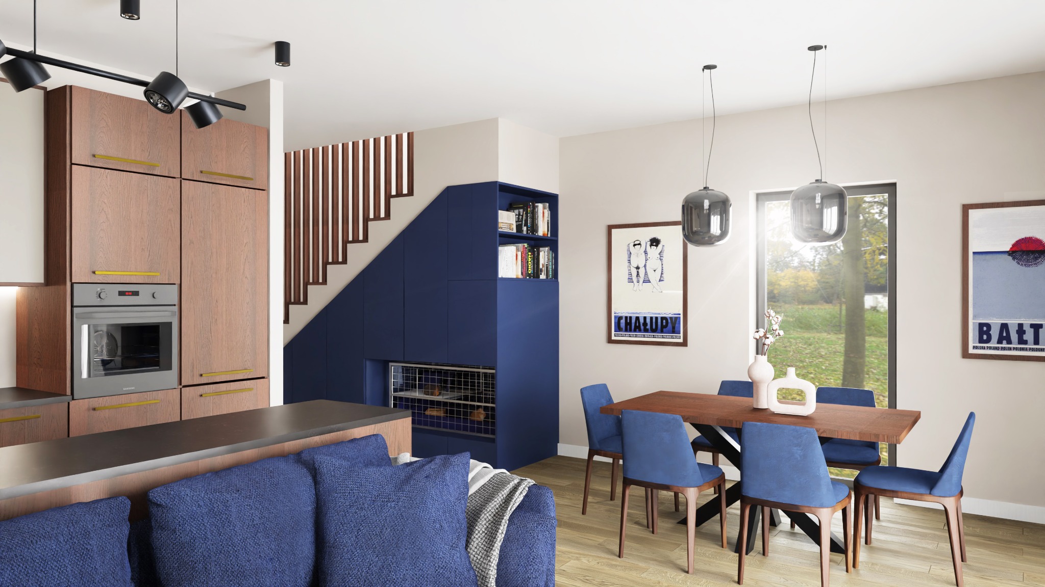 Nowoczesne wnętrze domu z otwartą kuchnią i jadalnią, niebieska zabudowa pod schodami z regałami na książki, drewniane szafki kuchenne z piekarnikiem, stół jadalny z niebieskimi krzesłami, szare...