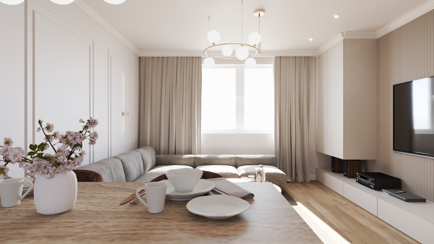 Jasne wnętrze salonu z jadalnią: sofa, stół z zastawą, kwiaty w wazonie. Neutralna kolorystyka, minimalistyczny design, drewniana podłoga i telewizor na ścianie.