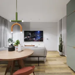 Wnętrze nowoczesnego salonu z okrągłym drewnianym stołem, pomarańczowymi krzesłami, szarą sofą i telewizorem z włączonym obrazem, oświetlone oryginalną lampą z elementami zieleni i pomarańczy.