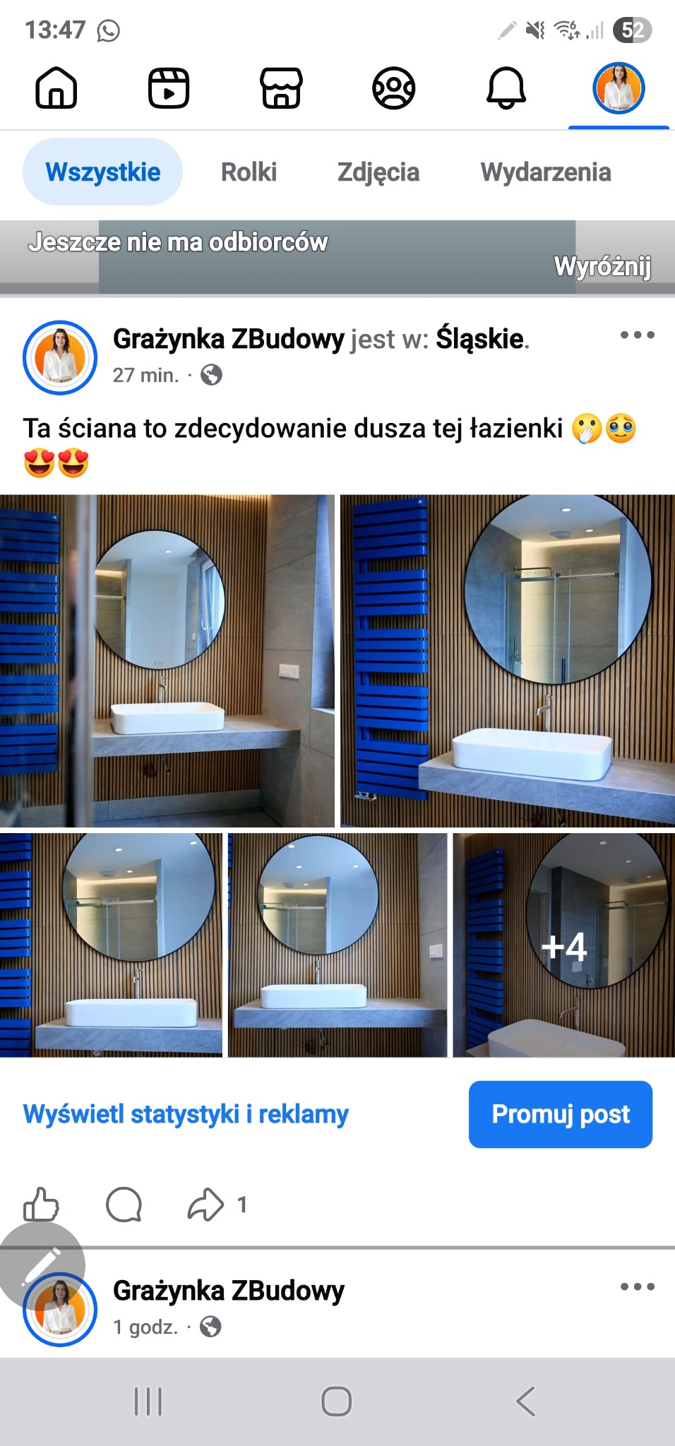 Nowoczesna łazienka po remoncie: drewniana ściana, okrągłe lustro, biała umywalka na kamiennym blacie i niebieski grzejnik. Widok z profilu Facebooka.