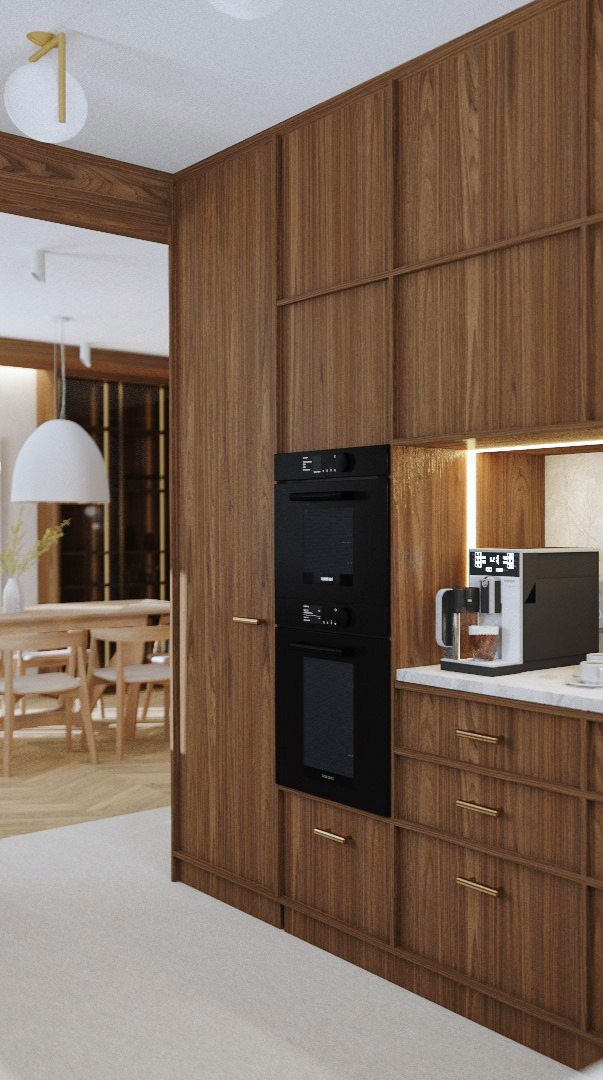 Nowoczesna kuchnia z drewnianymi frontami, wbudowanym piekarnikiem i ekspresem do kawy. Widok na jadalnię z białym, okrągłym żyrandolem. Minimalistyczny design.