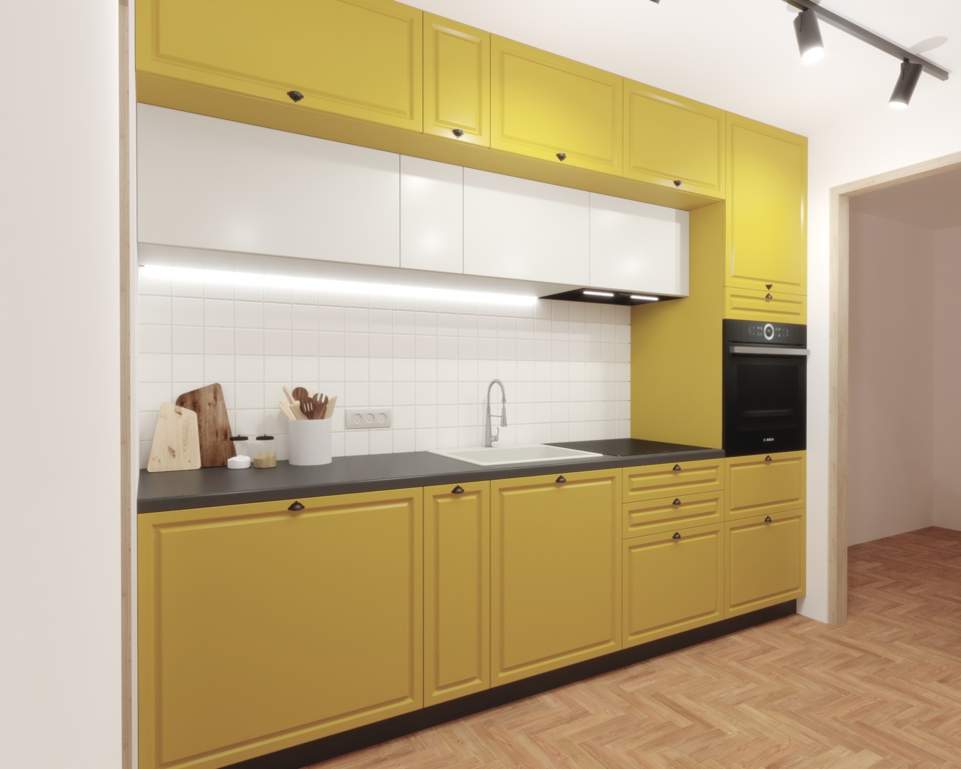 Żółta kuchnia z białymi szafkami wiszącymi, czarnym blatem i parkietem ułożonym w jodełkę, oświetlona reflektorami.