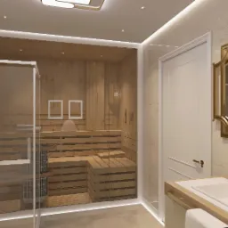 Nowoczesna łazienka z sauną za szklaną ścianą, jasne płytki, złote akcenty w armaturze i lustrze. Minimalistyczny design z dbałością o detale.