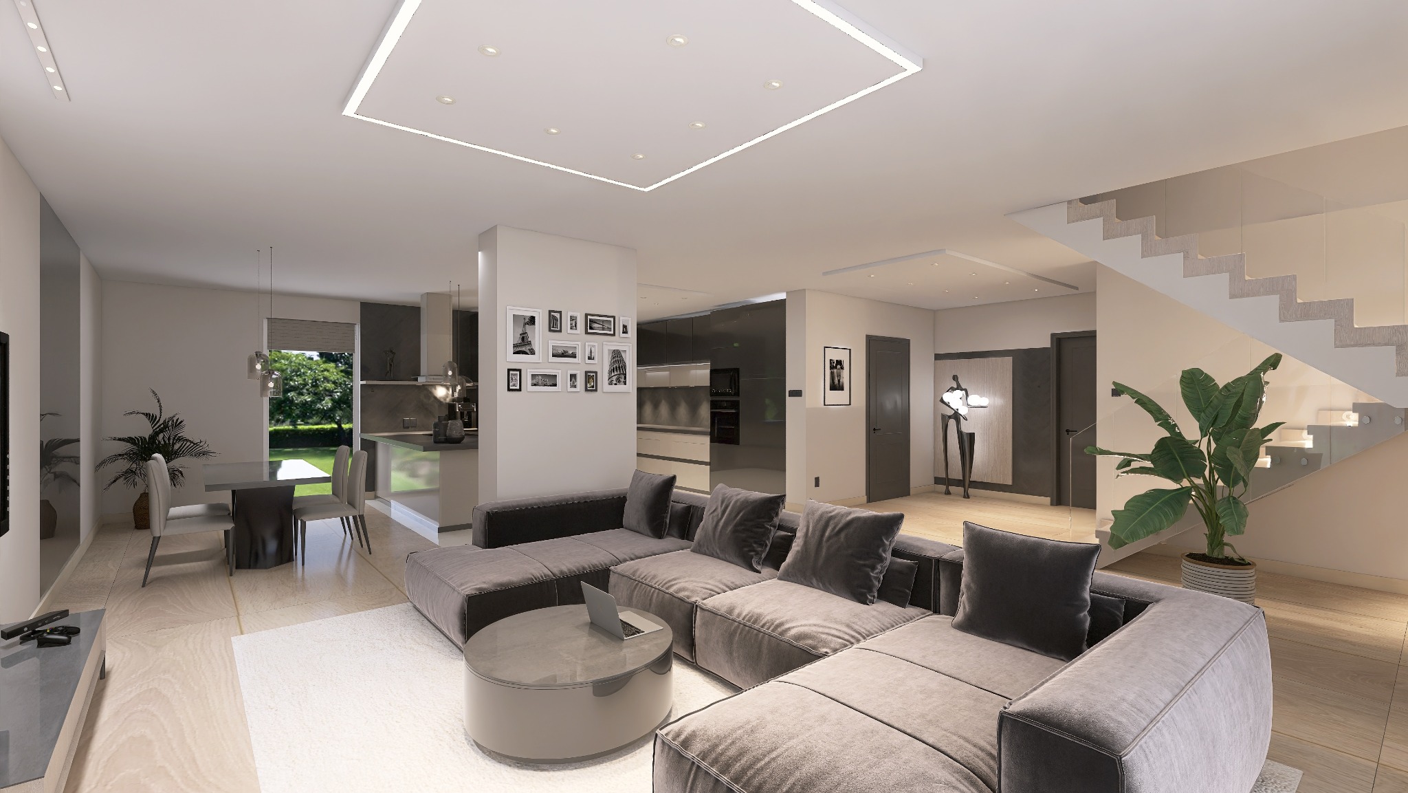 Nowoczesny salon z szarą sofą modułową, okrągłym stolikiem kawowym z laptopem i schodami z przeszkloną balustradą. Minimalistyczne oświetlenie sufitowe.