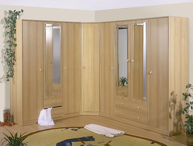 Jasna, narożna szafa z lustrami, otwartą szufladą i dekoracjami roślinnymi w tle, na okrągłym dywanie.